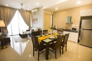 a kitchen and dining room with a table and chairs at D'Pristine Medini By The one - 8min walk to Legoland in Nusajaya