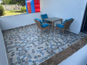 a table and chairs sitting on a tiled floor at Hotel Atlantic Costinesti in Costinesti
