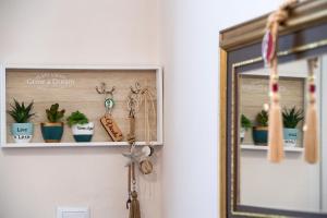 a shelf with potted plants and a mirror at Vicolo Appartamenti Locali by Imagine Lefkada in Lefkada Town