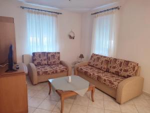 a living room with a couch and a chair at Aspri Ammos House in Kavála