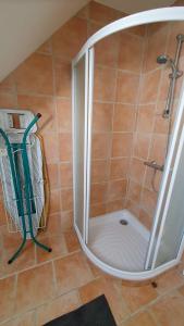 a shower with a glass door in a bathroom at Tout le confort au milieu d'un parc botanique in Noyal-Muzillac