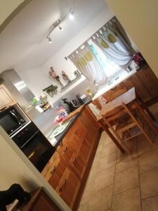 a kitchen with wooden cabinets and a stove top oven at The happy house in Le Martinet