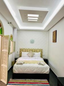 a bedroom with a large bed in a room at DAR Riad Jomana in Marrakech