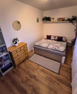 a small bedroom with a bed and a dresser at House of Relax in Řečany nad Labem