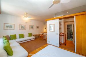 a living room with a white couch and green pillows at Seaview Open Space Loft by PortofinoVip in Portofino