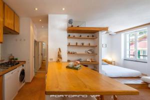 a kitchen with a wooden table in a room at Seaview Open Space Loft by PortofinoVip in Portofino