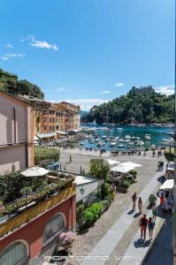 a group of people walking on a street next to a harbor at Seaview Open Space Loft by PortofinoVip in Portofino