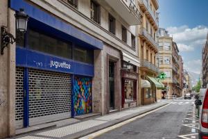 an empty city street with buildings and a store at Arrasate 2 by FeelFree Rentals in San Sebastián