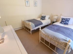 Ένα ή περισσότερα κρεβάτια σε δωμάτιο στο Jasmine Cottage