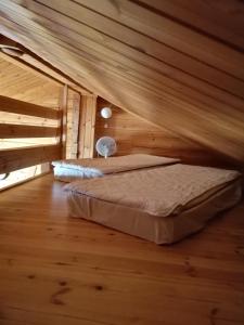 a bed in a room with a wooden ceiling at Isotalo Farm at enäjärvi lake in Salo