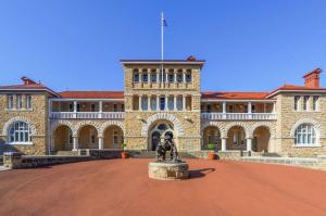 a large building with a fountain in front of it at Metro Hotel Perth City in Perth