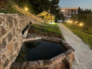 a stone wall with a pool of water in it at SUNSET BUKNARI in Buknari