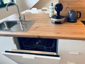 a kitchen counter with a sink and a stove at Villa Kovačeva 15, app 2, free parking in Ljubljana