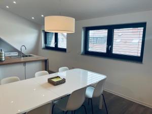 a kitchen with a white table and chairs at Villa Kovačeva 15, app 2, free parking in Ljubljana