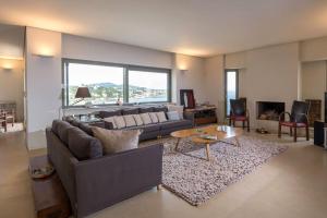 a living room with a couch and a table at Sounio Villa Poseidon Temple View in Sounio