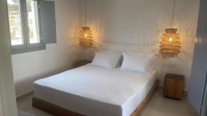 A bed or beds in a room at Sohoros Luxury Suites