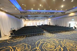 a large room with chairs and a stage in it at Leonardo Club Eilat - All Inclusive in Eilat