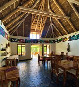 a dining room with wooden tables and chairs at Badger's Lodge in Knysna