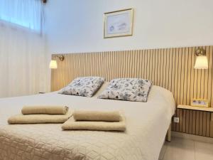 a bedroom with a bed with two pillows on it at Апартаменты Playa de la Arena in Puerto de Santiago