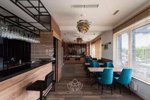 a dining room with blue chairs and tables at Hotel Polonia PARK Medical Center & Spa in Busko-Zdrój