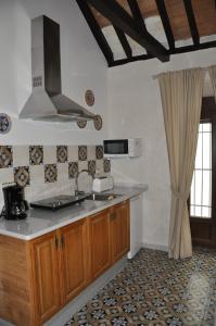 a kitchen with a sink and a stove top oven at Casa de las Remigias in Estepona