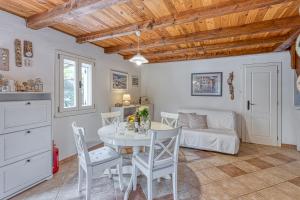 a kitchen and dining room with a table and chairs at Eco House Zabodarski Beach - Happy Rentals in Čunski