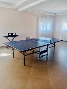 a ping pong table in the middle of a room at B&B/chambres d'hôtes in Antananarivo