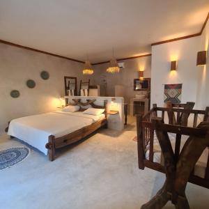 a bedroom with a large bed in a room at Mambo Cabana in Pwani Mchangani +81 photos