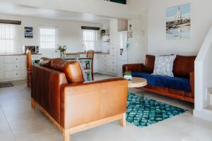 a living room with a couch and a table at Casa Rene in Paternoster