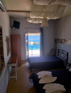 a bedroom with two beds and a view of the ocean at Meltemi in Posidhonía