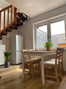 a dining room with a table and chairs and a staircase at Ferienhaus Dierdorf in Dierdorf