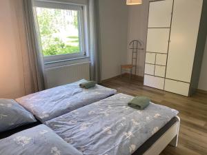 a bedroom with two beds and a window at Ferienhaus Dierdorf in Dierdorf