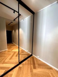 a room with mirrored walls and a wooden floor at Luxury City Center Suite in Helsinki