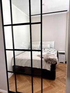 a room with a bed with a glass wall at Luxury City Center Suite in Helsinki