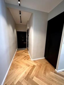 an empty room with a wooden floor and white walls at Luxury City Center Suite in Helsinki