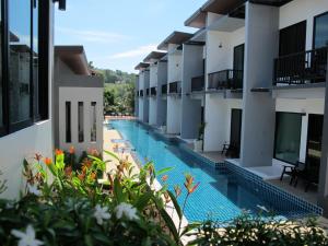a swimming pool in the middle of a building at Alphabeto Resort in Nai Harn Beach