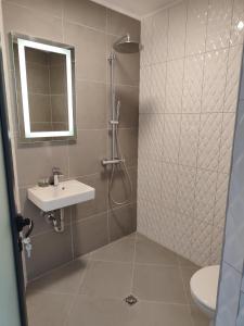 a bathroom with a shower and a sink at Marina Sarafovo in Burgas City