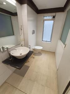 a bathroom with a sink and a toilet at Rapid Lakme Executive Hotel in Pune +30 photos