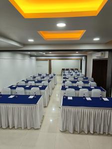 a row of tables in a room with blue and white at Rapid Lakme Executive Hotel in Pune