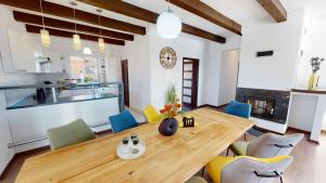 a kitchen and dining room with a wooden table and chairs at Dom v raji in Spišské Tomášovce