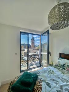 a bedroom with a bed and a large glass window at Amazing City Centre 1 bedroom Apartment with Balcony LGBTQ Friendly in Belfast