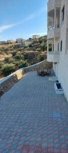 a balcony of a building with tables and chairs at Quiet stay in Jerash