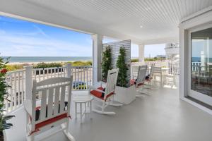 a porch with chairs and a view of the ocean at Cape May Ohana Beach Club in Cape May