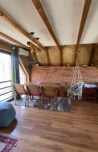 a room with a table and chairs and a brick wall at Cozy 3 bedroom mountain villa with scenic views in Novoberdo