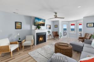 a living room with a couch and a fireplace at Cape May Ohana Beach Club in Cape May