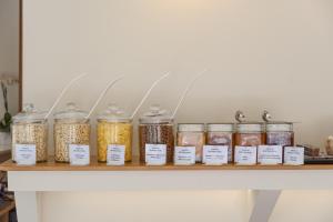 a shelf filled with jars of food on a counter at Nikon Boutique Hotel in Kalamaki