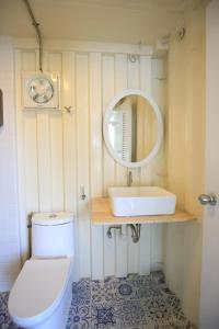 a bathroom with a white toilet and a sink at Day Off House Chiang Mai Near Walking Street in Chiang Mai