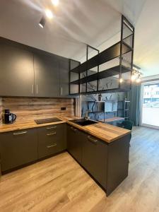 a kitchen with brown cabinets and a counter top at Apartament z ogródkiem nad morzem in Gdańsk