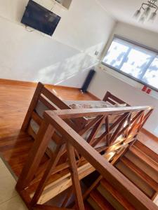 an overhead view of a room with wooden stairs and a tv at Apart Colon in Rufino