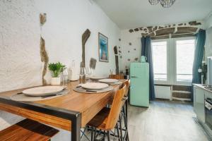 eine Küche mit einem Holztisch und einem grünen Kühlschrank in der Unterkunft Cabana & Le Petit Rousseau - Proche du Lac in Annecy